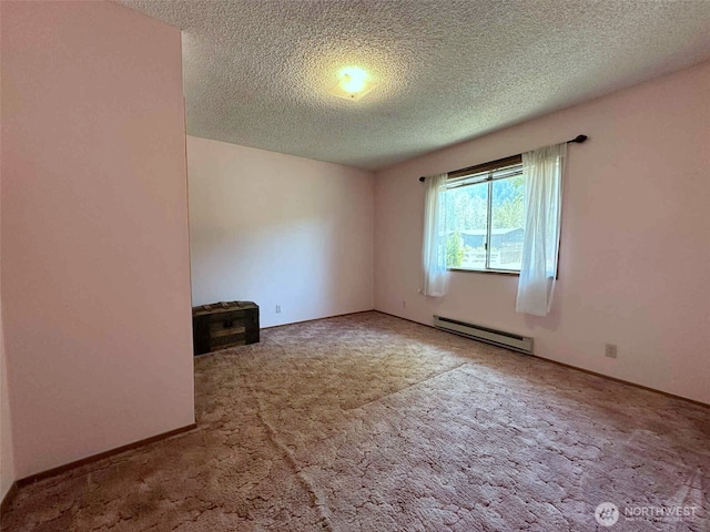 798 Division Ave, Morton, WA 98356 - carpeted empty room with a baseboard heating unit and a textured ceiling