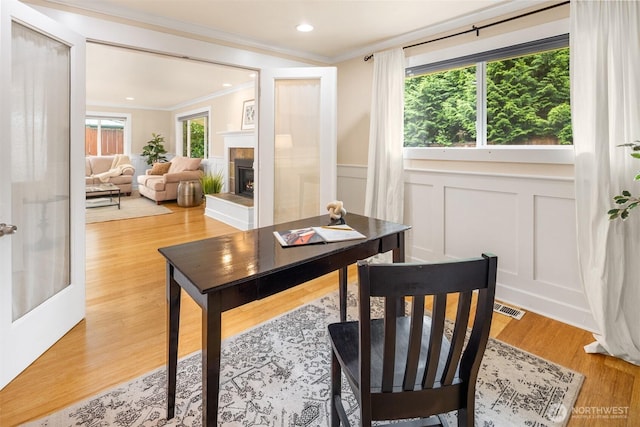 108 151st Pl SE, Lynnwood, WA 98087 - office space featuring ornamental molding, a decorative wall, a tile fireplace, a wainscoted wall, and light wood finished floors