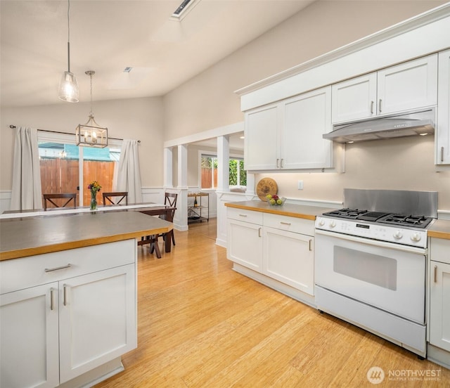 108 151st Pl SE, Lynnwood, WA 98087 - kitchen featuring white gas range oven, under cabinet range hood, light wood-style flooring, hanging light fixtures, and white cabinets
