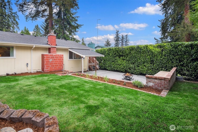 108 151st Pl SE, Lynnwood, WA 98087 - view of green lawn featuring an outdoor fire pit and a patio area