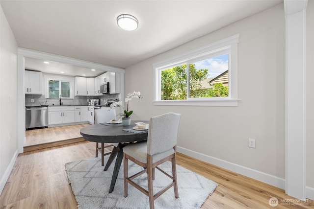 6416 S Huson St, Tacoma, WA 98409 - dining space with light wood-style flooring and baseboards