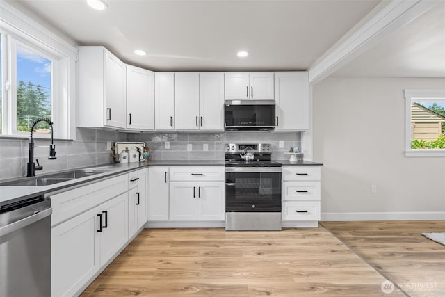 6416 S Huson St, Tacoma, WA 98409 - kitchen featuring stainless steel appliances, decorative backsplash, white cabinetry, recessed lighting, and light wood finished floors