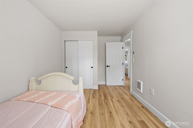 6416 S Huson St, Tacoma, WA 98409 - bedroom with light wood-style floors, a closet, and heating unit