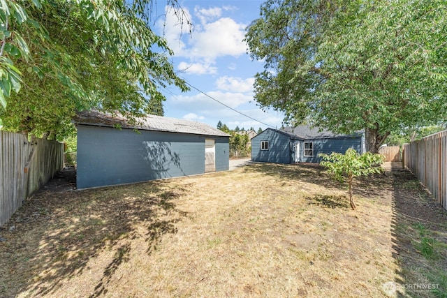 6416 S Huson St, Tacoma, WA 98409 - fenced backyard featuring an outbuilding