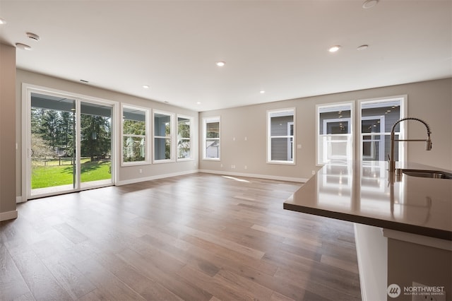 21725 SE 292 Nd Pl, Black Diamond, WA 98010 - unfurnished living room with plenty of natural light, wood finished floors, and recessed lighting