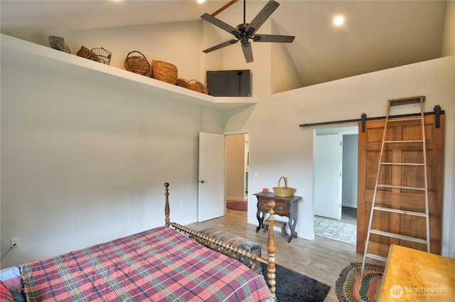 53 E Elma Mccleary Rd, Elma, WA 98514 - bedroom with high vaulted ceiling, wood finished floors, and a barn door