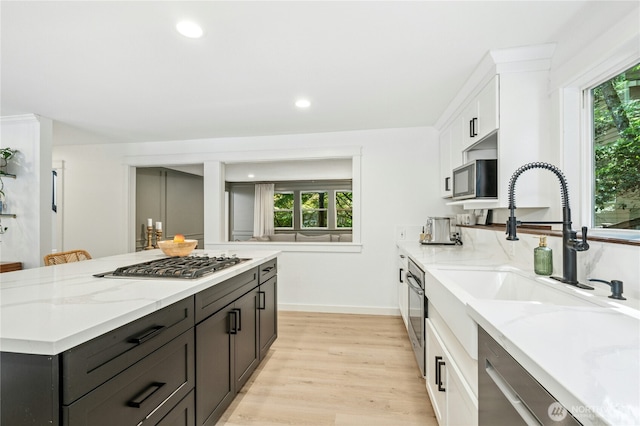 17519 33rd Ave NE, Lake Forest Park, WA 98155 - kitchen with appliances with stainless steel finishes, white cabinetry, light stone countertops, healthy amount of natural light, and recessed lighting