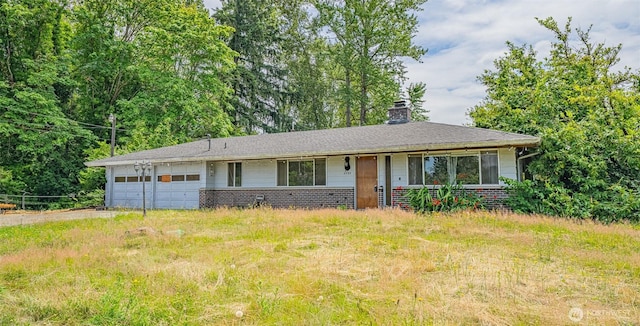 5735 NE 8th St, Renton, WA 98059 - ranch-style house featuring a chimney, a garage, brick siding, and driveway