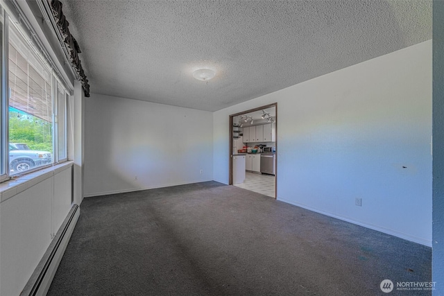 5735 NE 8th St, Renton, WA 98059 - spare room with a baseboard heating unit, carpet, and a textured ceiling
