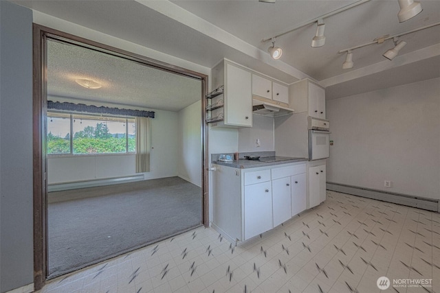 5735 NE 8th St, Renton, WA 98059 - kitchen featuring a baseboard radiator, white oven, baseboard heating, white cabinets, and black electric cooktop