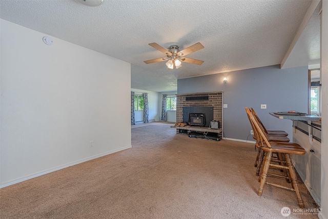 5735 NE 8th St, Renton, WA 98059 - living room with carpet flooring, a textured ceiling, ceiling fan, and a fireplace