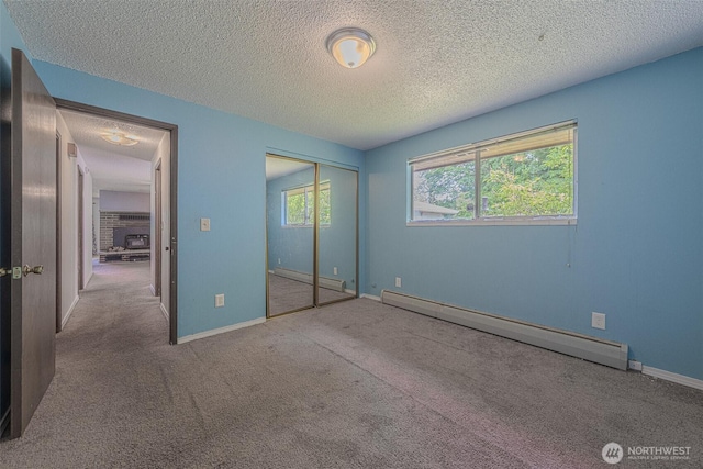 5735 NE 8th St, Renton, WA 98059 - unfurnished bedroom featuring a baseboard radiator, carpet, a textured ceiling, and a closet