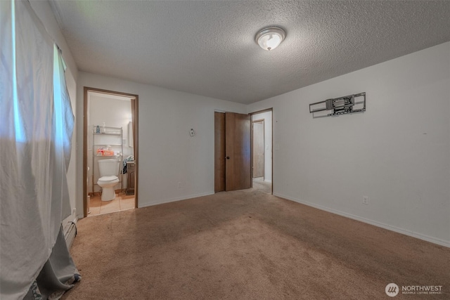 5735 NE 8th St, Renton, WA 98059 - unfurnished bedroom with a textured ceiling, carpet flooring, and ensuite bath