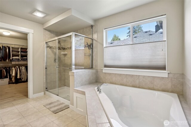 13218 106th Pl NE, Kirkland, WA 98034 - full bathroom featuring a stall shower, a garden tub, a spacious closet, and tile patterned flooring