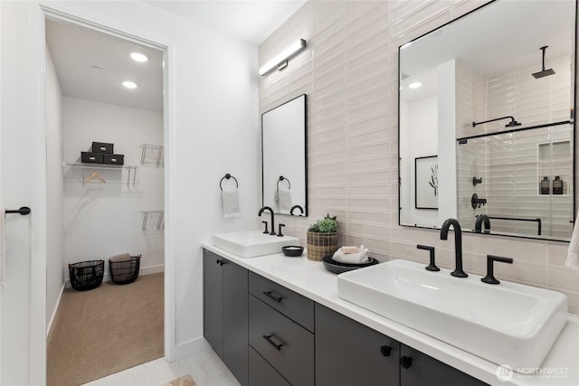 12207 137th Pl NE Unit 2602, Redmond, WA 98052 - bathroom featuring double vanity, a spacious closet, tiled shower, tasteful backsplash, and recessed lighting