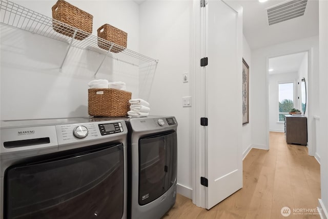 12207 137th Pl NE Unit 2602, Redmond, WA 98052 - washroom featuring washing machine and clothes dryer and light wood-type flooring