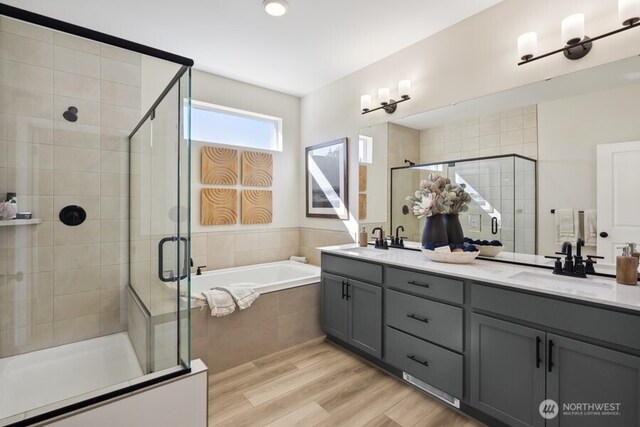 4273 Aberdeen Way NE, Renton, WA 98056 - bathroom with double vanity, a stall shower, a bath, and wood finished floors