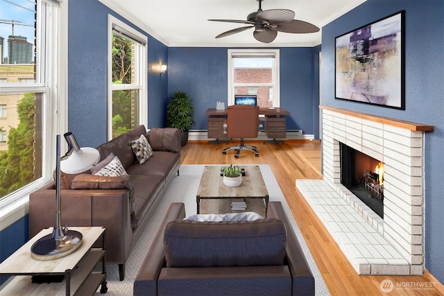 404 E Harrison St Unit 301, Seattle, WA 98102 - living room with wood finished floors, crown molding, a brick fireplace, an office area, and a ceiling fan