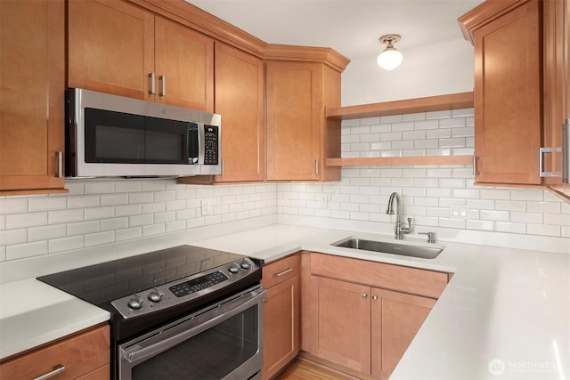 404 E Harrison St Unit 301, Seattle, WA 98102 - kitchen featuring stainless steel appliances, open shelves, light countertops, and tasteful backsplash