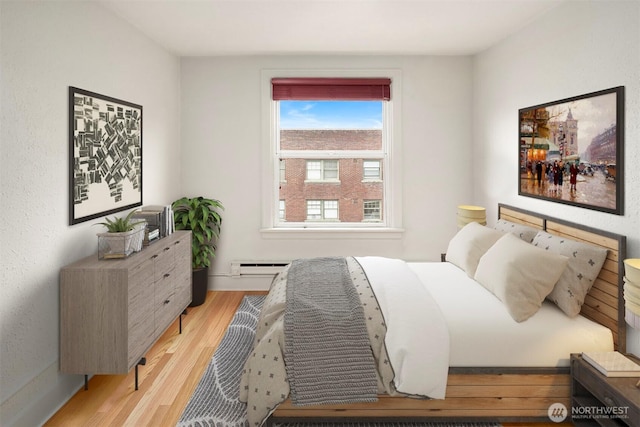 404 E Harrison St Unit 301, Seattle, WA 98102 - bedroom with light wood-style floors and a baseboard heating unit