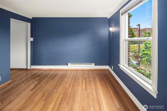 404 E Harrison St Unit 301, Seattle, WA 98102 - empty room with a baseboard radiator, ornamental molding, and wood finished floors