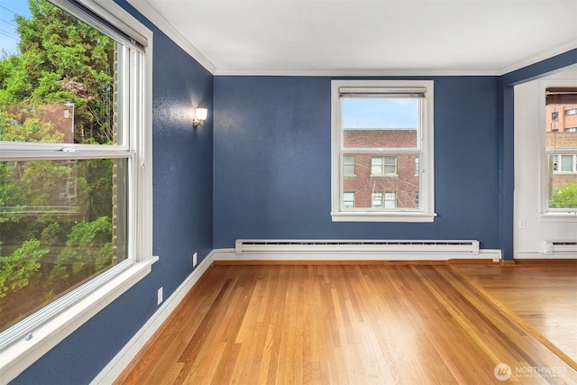 404 E Harrison St Unit 301, Seattle, WA 98102 - empty room with baseboard heating, wood finished floors, and crown molding