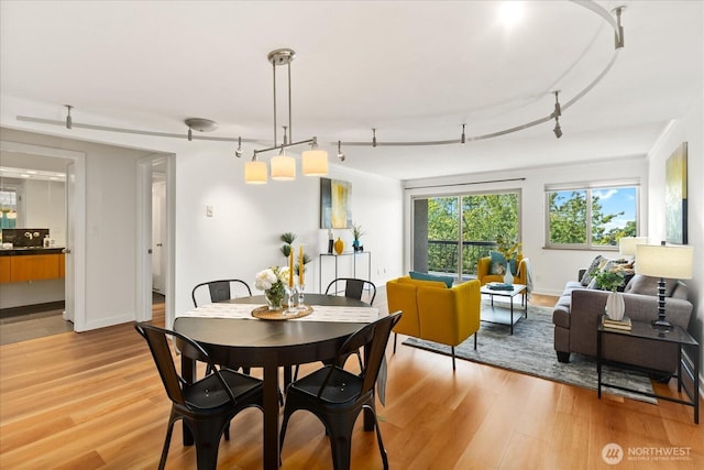 732 11th Ave E Unit 404, Seattle, WA 98102 - dining room with light wood-type flooring and track lighting