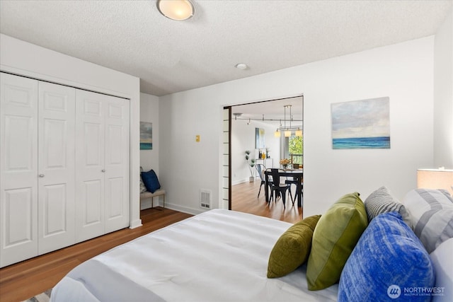 732 11th Ave E Unit 404, Seattle, WA 98102 - bedroom with wood finished floors, a closet, and a textured ceiling