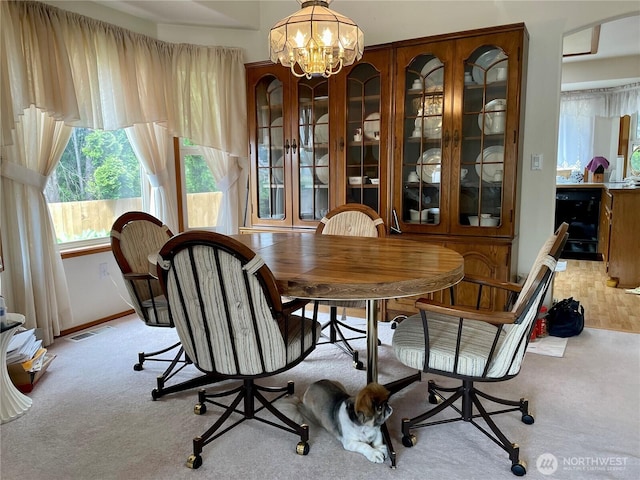 9238 Classic Dr NE, Lacey, WA 98516 - dining space with light carpet, healthy amount of natural light, and a chandelier