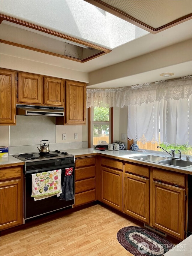9238 Classic Dr NE, Lacey, WA 98516 - kitchen with black electric range oven, brown cabinets, under cabinet range hood, and light countertops