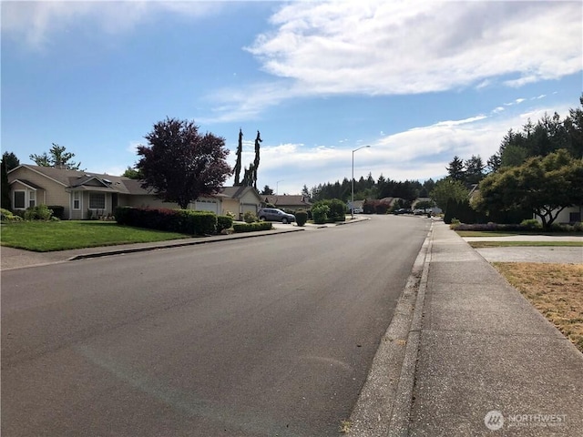 9238 Classic Dr NE, Lacey, WA 98516 - view of asphalt street featuring sidewalks, curbs, street lights, and a residential view