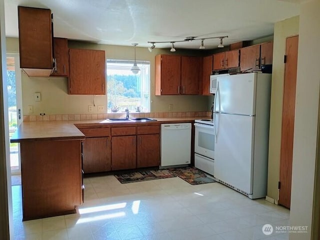 3295 Hastings Ave, Port Townsend, WA 98368 - kitchen featuring white appliances, light countertops, and brown cabinetry
