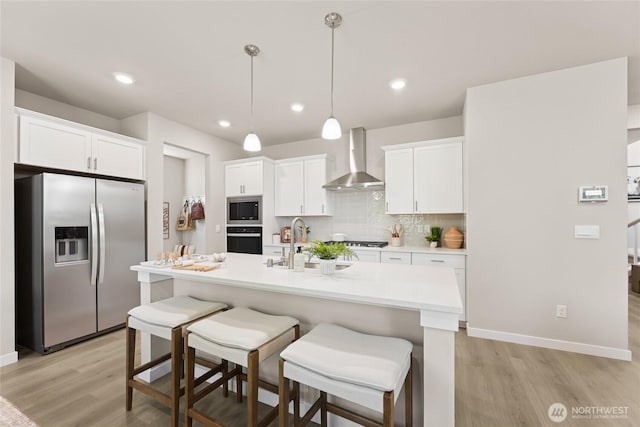 26817 NE 143rd Cir Unit 03, Duvall, WA 98019 - kitchen with appliances with stainless steel finishes, wall chimney exhaust hood, light wood-style flooring, light countertops, and white cabinets