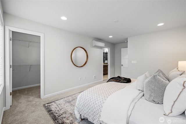 7629 NE 122nd Ct Unit 7, Kirkland, WA 98034 - bedroom with a spacious closet, light colored carpet, an AC wall unit, recessed lighting, and ensuite bath