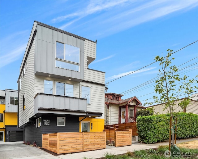 727 18th Ave, Seattle, WA 98122 - contemporary house featuring board and batten siding, driveway, and an attached garage