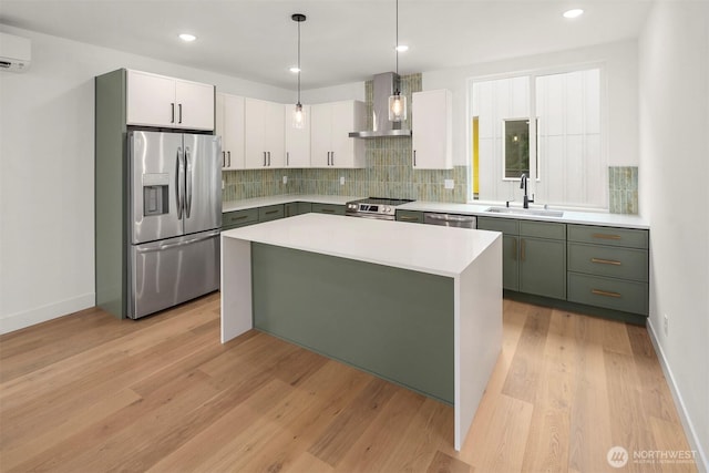 727 18th Ave, Seattle, WA 98122 - kitchen with stainless steel appliances, wall chimney exhaust hood, green cabinets, backsplash, and light wood-type flooring