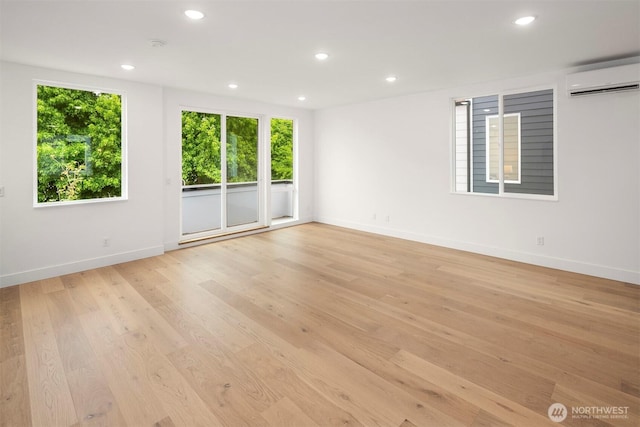 727 18th Ave, Seattle, WA 98122 - unfurnished room featuring a wall mounted air conditioner, healthy amount of natural light, recessed lighting, and light wood-type flooring