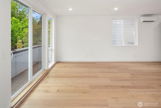 727 18th Ave, Seattle, WA 98122 - empty room featuring an AC wall unit, light wood-style flooring, and recessed lighting