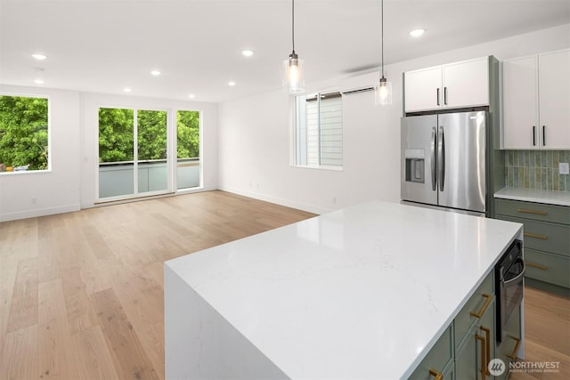 727 18th Ave, Seattle, WA 98122 - kitchen with stainless steel fridge with ice dispenser, a kitchen island, tasteful backsplash, light wood-type flooring, and hanging light fixtures