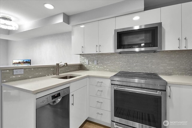 425 Vine St Unit 614, Seattle, WA 98121 - kitchen featuring appliances with stainless steel finishes, light countertops, white cabinets, and recessed lighting