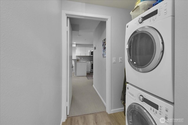 425 Vine St Unit 614, Seattle, WA 98121 - washroom with stacked washer / dryer and light wood-style floors