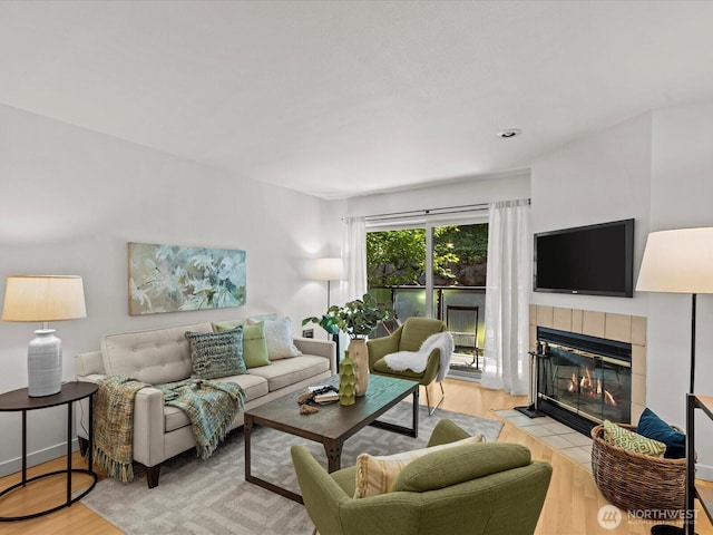 5225 50th Ave NE Unit 103, Seattle, WA 98105 - living room featuring a fireplace and wood finished floors