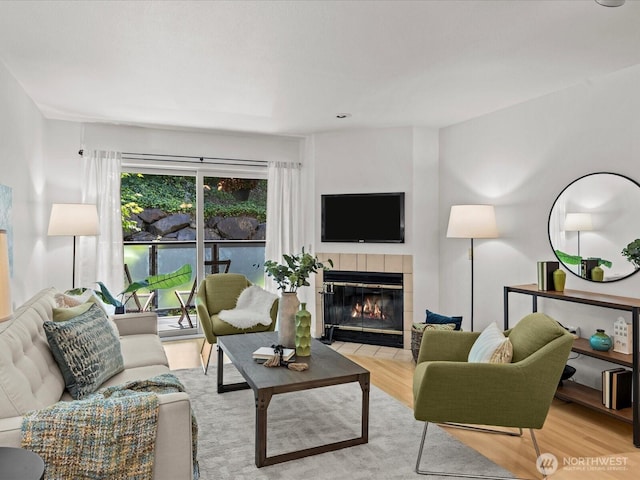 5225 50th Ave NE Unit 103, Seattle, WA 98105 - living room with light wood-type flooring and a tile fireplace