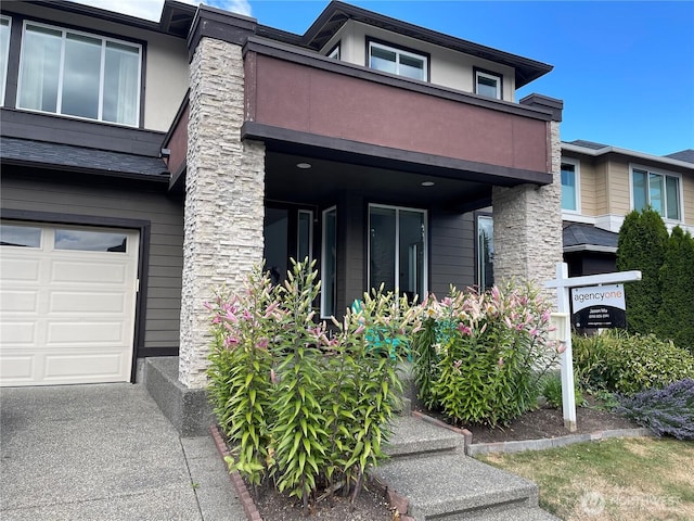 16486 SE 46th Ct, Bellevue, WA 98006 - view of front of home with a balcony, a garage, and stucco siding