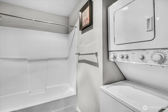 425 Vine St Unit 421, Seattle, WA 98121 - full bathroom featuring estacked washer and dryer and bathtub / shower combination