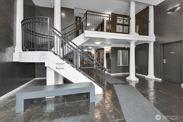 425 Vine St Unit 421, Seattle, WA 98121 - staircase featuring decorative columns and a towering ceiling