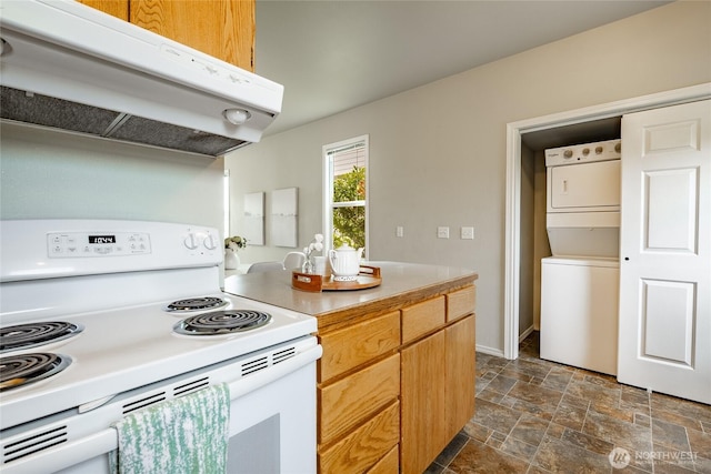 1609 Humboldt St, Bellingham, WA 98225 - kitchen featuring white range with electric cooktop, stacked washer / dryer, range hood, stone finish flooring, and light countertops