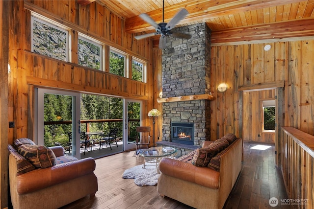 7189 Icicle Rd, Leavenworth, WA 98826 - living area with wood walls, a wood ceiling with exposed beams, wood-type flooring, a ceiling fan, and a towering ceiling