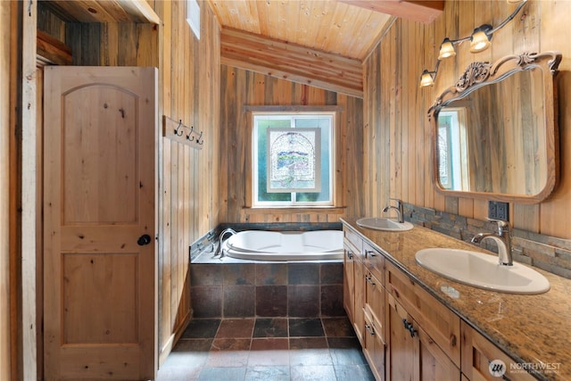 7189 Icicle Rd, Leavenworth, WA 98826 - full bathroom featuring a garden tub, double vanity, stone tile flooring, wood walls, and lofted ceiling