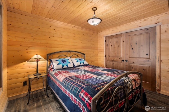 7189 Icicle Rd, Leavenworth, WA 98826 - bedroom with dark wood-type flooring, wood walls, wooden ceiling, and a closet